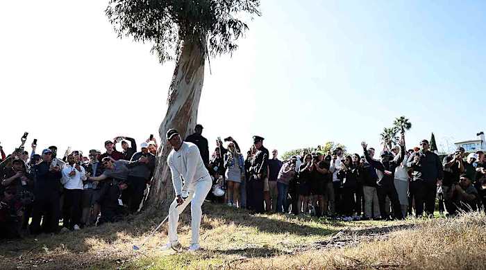 Tiger Woods lines up his shot on the 18th hole during the first round of the 2024 Genesis Invitational at Riviera Country Club in Pacific Palisades, Calif.